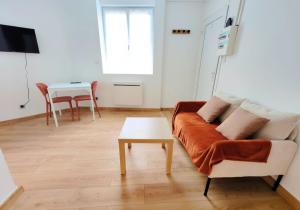 a living room with a couch and a table at L'Horizon - AbsoluteHome in Croix