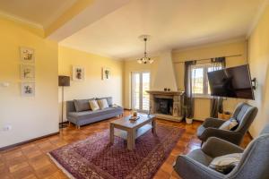 a living room with couches and a tv at Casa Outeiro 99 in Paredes de Coura