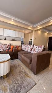 a living room with two couches and a couch at Kaisa Gardens in Nairobi