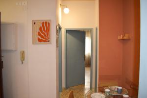 a hallway with a glass table and an orange wall at La casetta di Leo in Poggibonsi +20 photos