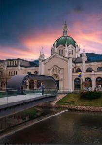 a large white building with a green dome and a bridge at Studio - Bee Happy in Sarajevo