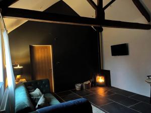 a living room with a couch and a fireplace at Torworth - 1 Bed Barn - Sleeps 3 - Hot Tub in Torworth