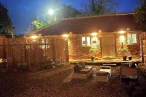 a brick house with a fence in front of it at Torworth - 1 Bed Barn - Sleeps 3 - Hot Tub in Torworth