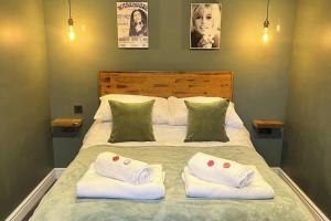 a bedroom with a bed with two towels on it at Torworth - 1 Bed Barn - Sleeps 3 - Hot Tub in Torworth