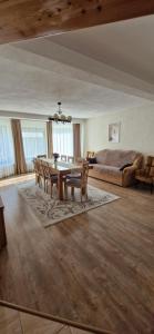 a living room with a table and chairs and a couch at Cabana Valea Muntelui in Poiana Mărului