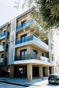 a building with a car parked in front of it at Dreamer's Luxury Suites in Volos