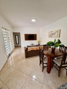 a living room with a table and a couch at Chacara Souza in Socorro