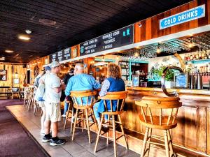 a group of people sitting at a bar at Fisherman's Wharf Inn in Boothbay Harbor