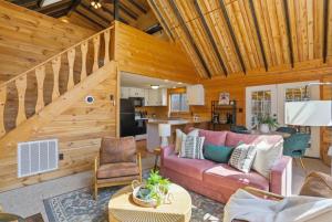 a living room with a couch and a kitchen at Dog-Friendly A-Frame with Hot Tub and Firepit in Hedgesville