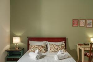a bedroom with a bed with towels on it at AROI Studio in Patra