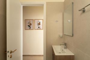a bathroom with a sink and a mirror at AROI Studio in Patra +5 photos