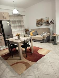 a living room with a table and a couch at Vagelis Nemea apartments in Neméa +33 photos