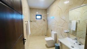 a bathroom with a toilet and a sink at Seaside Residence Negombo in Negombo