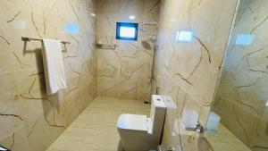 a bathroom with a sink and a toilet in it at Seaside Residence Negombo in Negombo +3 photos