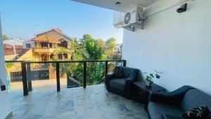 a living room with a couch and a balcony at Seaside Residence Negombo in Negombo