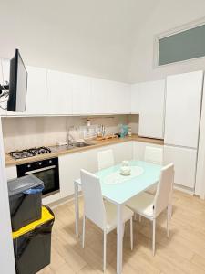 a kitchen with a table and chairs in a kitchen at Dimora Vanni "civico 5" "civico 9" in Polignano a Mare