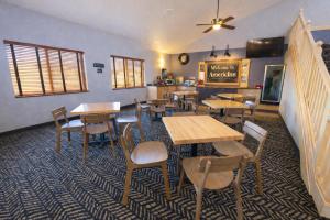 a restaurant with tables and chairs in a room at AmericInn by Wyndham Okoboji in Okoboji