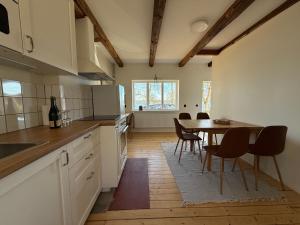 a kitchen with a table and chairs in a room at Fiskarhuset seaside cottage 2-6 pax in Sjöbo
