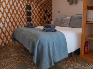 a bedroom with a bed with towels on it at Finca Feliz Andaluz in Alora +60 photos