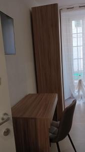 a desk and a chair in a room with a window at Apartment for 4 in Cairo Montenotte