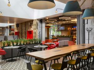 a restaurant with tables and chairs in a room at ibis Kyiv Beresteiska in Kyiv
