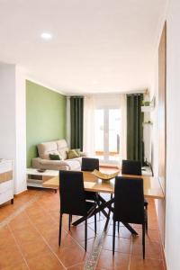 a living room with a table and chairs and a couch at Heavenly Homes Mojacar 75 in Mojácar