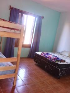 a bedroom with two bunk beds and a window at Paraíso chuí in Santa Vitória do Palmar