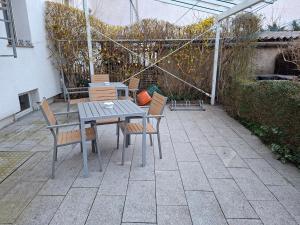 a table and chairs sitting on a patio at Pension Reichel in Freiberg