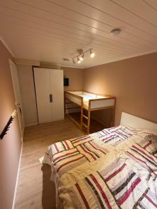 a bedroom with a bed and a desk in it at Lykkebo in Stavanger