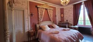 a bedroom with a large bed with pink walls at Suite familiale PAMPILLES in Condal