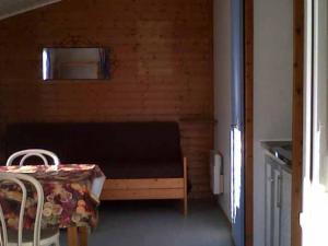 a small room with a bed and a table and chairs at Chalet avec terrasse - 6 pers. - API-1-52-2172 in Girac +18 photos