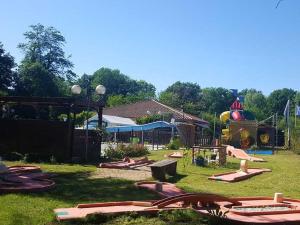 a park with a playground with a roller coaster at Chalet avec terrasse - 6 pers. - API-1-52-2172 in Girac