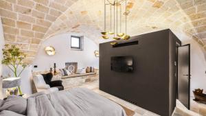 a bedroom with a bed and a living room at Bambarone L'Agriturismo in Fasano