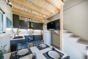 a kitchen and dining room with a table and chairs at Kallistis Home in Kontokali