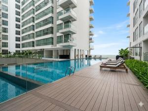 a swimming pool in front of a building at Ehsan Suites in Kuala Lumpur