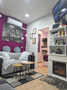 a living room with a couch and a fireplace at Casa Atocha 1913 Apartamento Histórico con Encanto in Madrid +54 photos