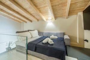 a bedroom with a bed with two towels on it at Kallistis Home in Kontokali +41 photos