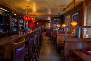 a bar with wooden tables and chairs in a restaurant at The Washington House Hotel & Restaurant in Sellersville