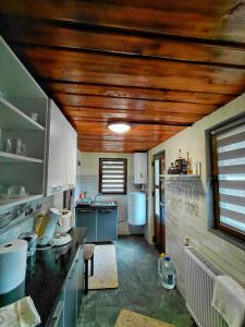 a kitchen with wooden ceilings and a counter top at Cabana MARA in Poiana Vadului
