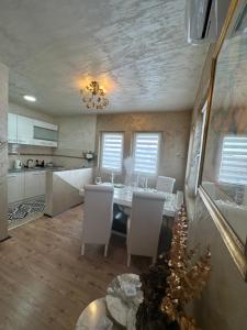 a kitchen and dining room with a table and chairs at Christian Dior Lazarevac in Lazarevac +12 photos