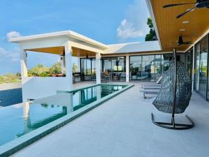 a home with a swimming pool and a house at Villa luxurious in Koh Samui