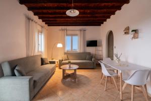 a living room with a couch and a table at Hillside Collection - by Hospirit in Mikonos