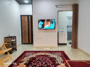 a living room with a tv on the wall at Hurghada Red Sea Apartments in Hurghada