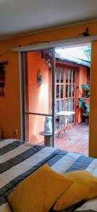a bedroom with a bed and a sliding glass door at La Casa de los Cactus in Coquimbo