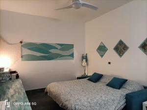 a bedroom with a bed and a ceiling fan at Casa Mario in Loano