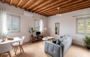 a living room with a couch and a table at Hillside Collection - by Hospirit in Mikonos