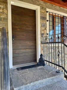 a teddy bear sitting in front of a door at Charmantes Rustico La Vedetta mit Terrasse in Minusio