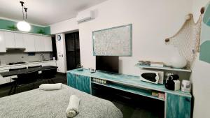 a kitchen with a blue desk in a room at Casa Mario in Loano +14 photos
