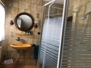 a bathroom with a sink and a mirror and a shower at Appartement Blickfang in Bruck an der Mur