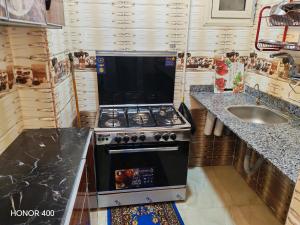 a small kitchen with a stove and a sink at Hurghada Red Sea Apartments in Hurghada